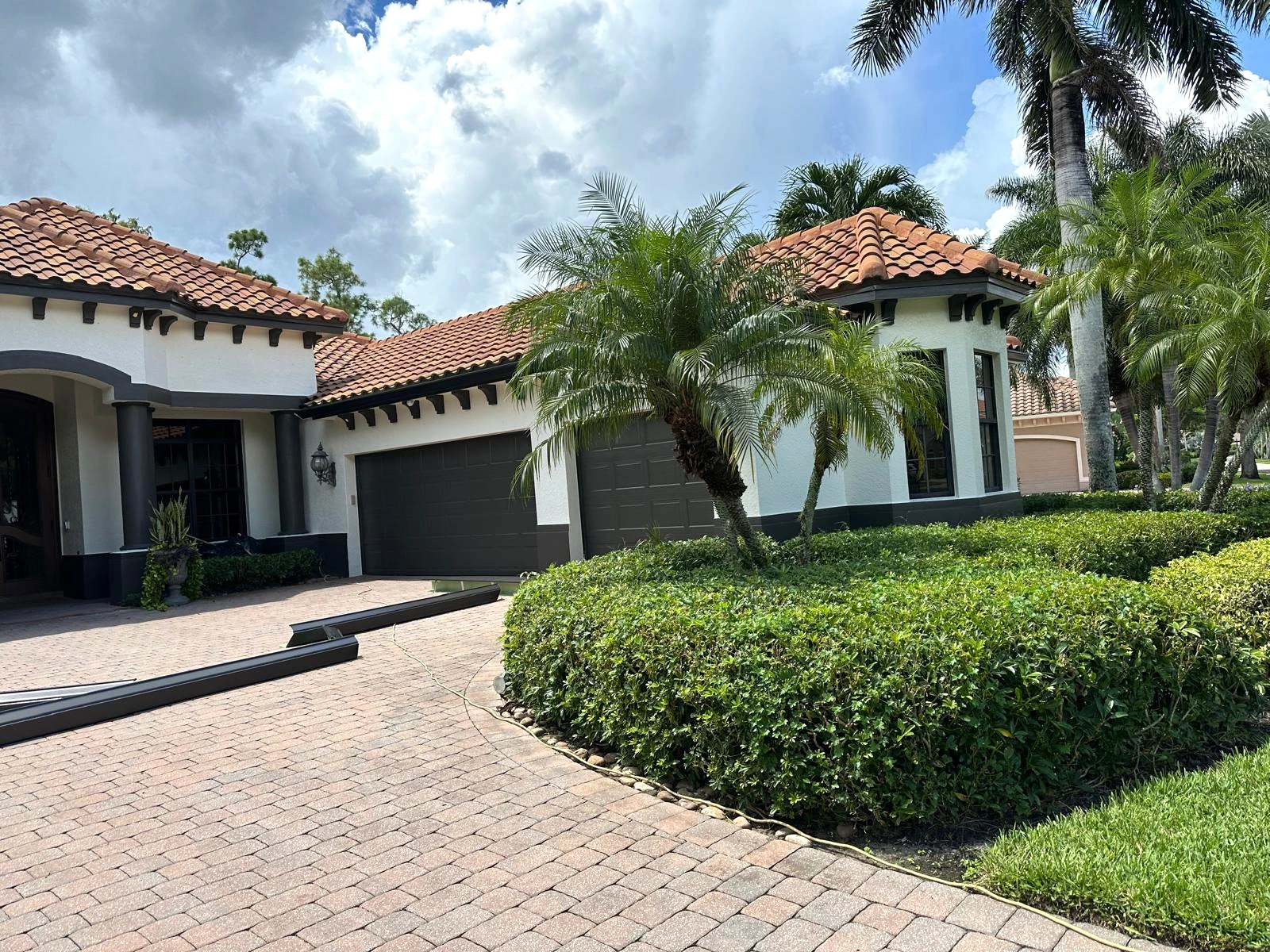 Dark gutters along the roofline of a tile-roof home