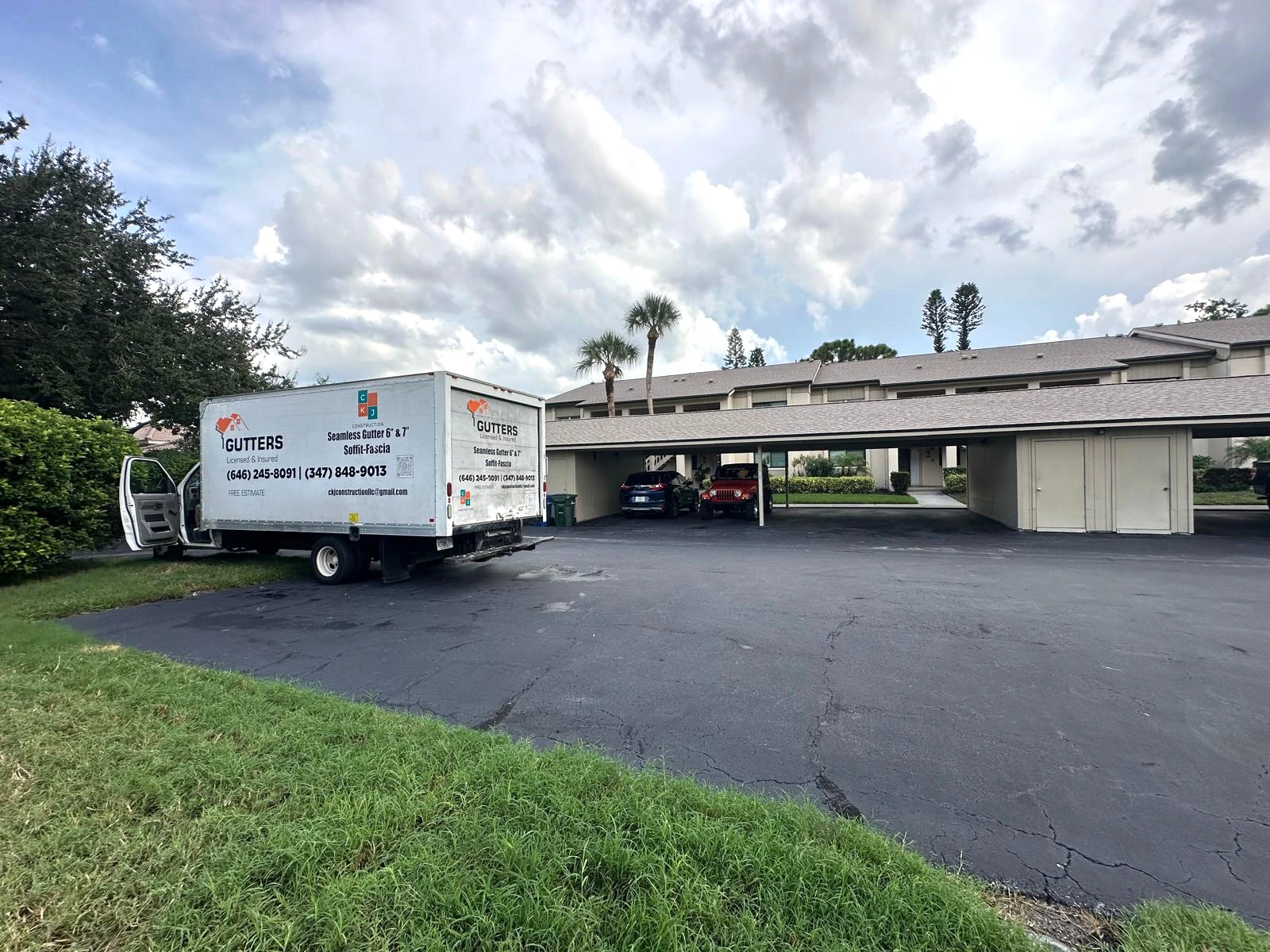 CKJ gutter truck beside a multi-building property